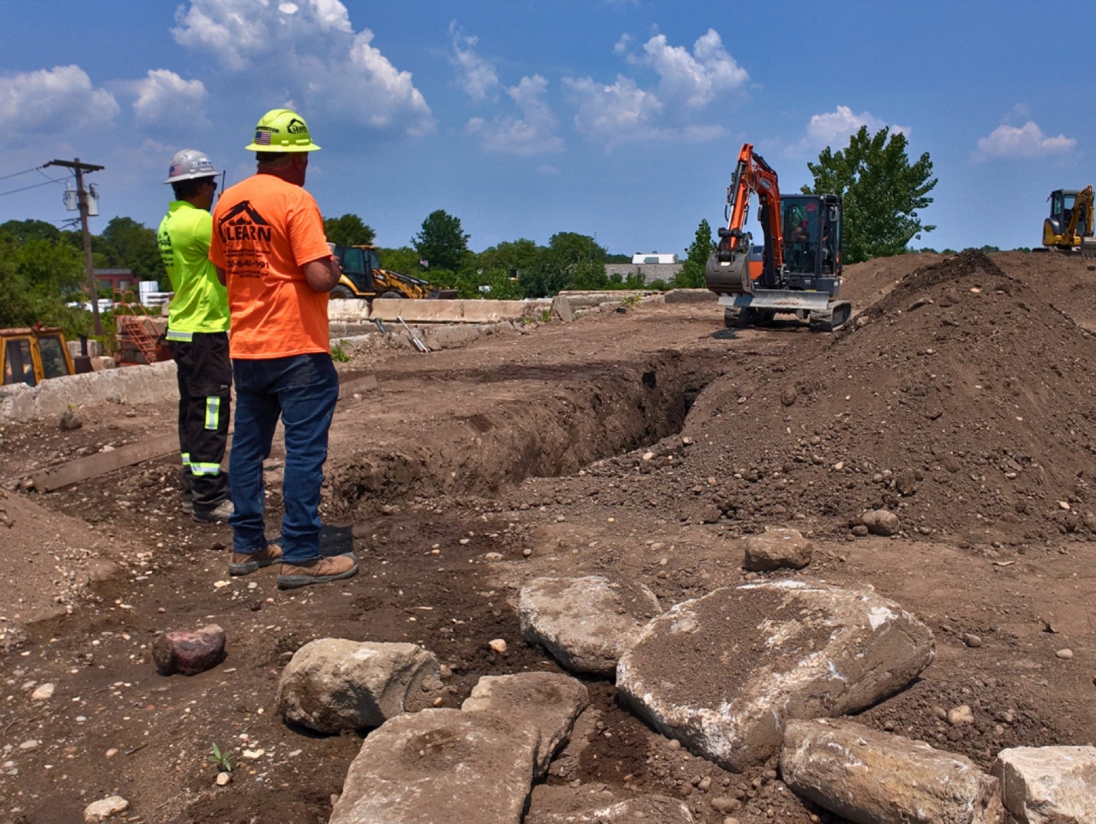Excavator trenching in the training yard